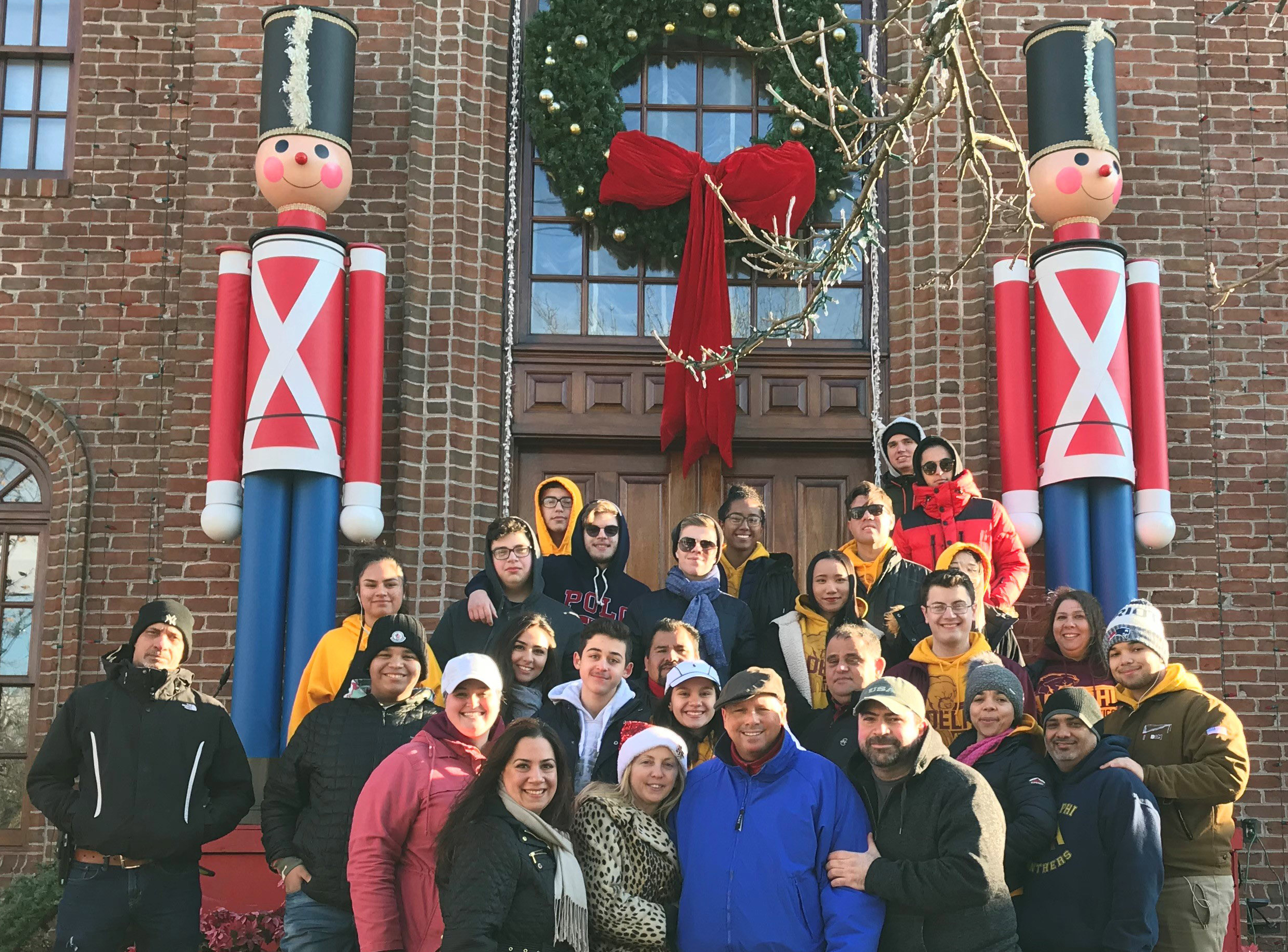 Adelphians join Mr. Joseph Mure Jr. and family in front of their home, the site of the 2018 Little North Pole event!