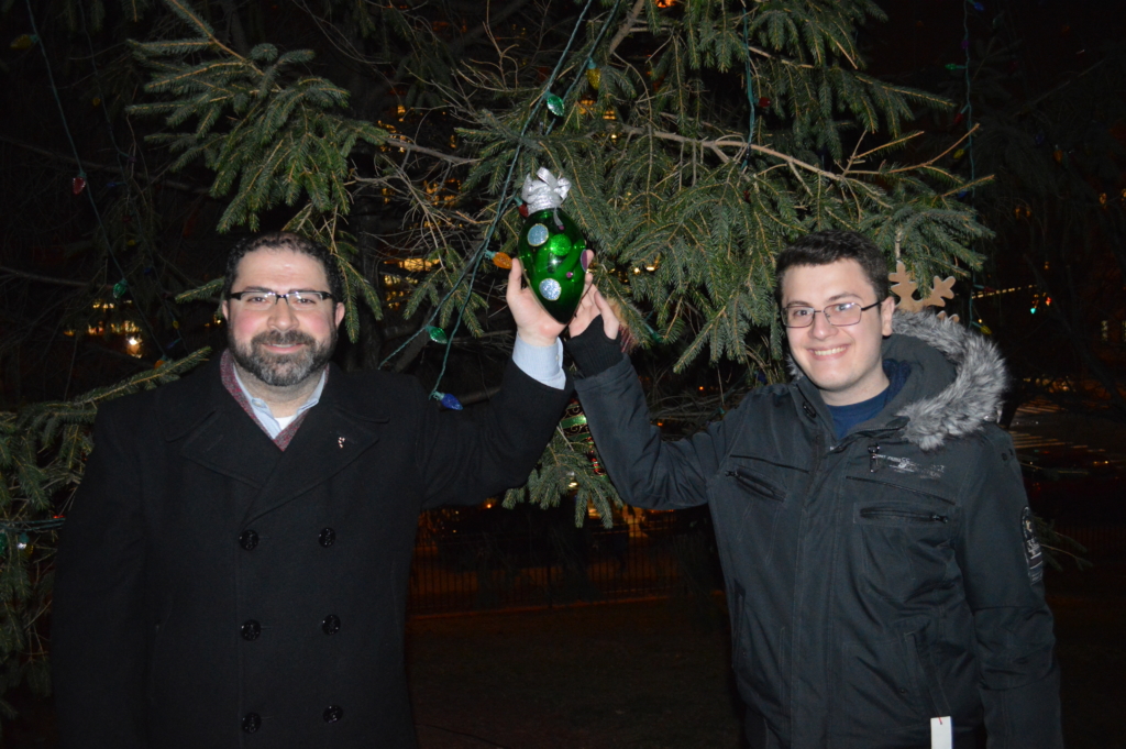 Class of 2019 member Arber hangs the Upper School ornament with Mr. Corhan.