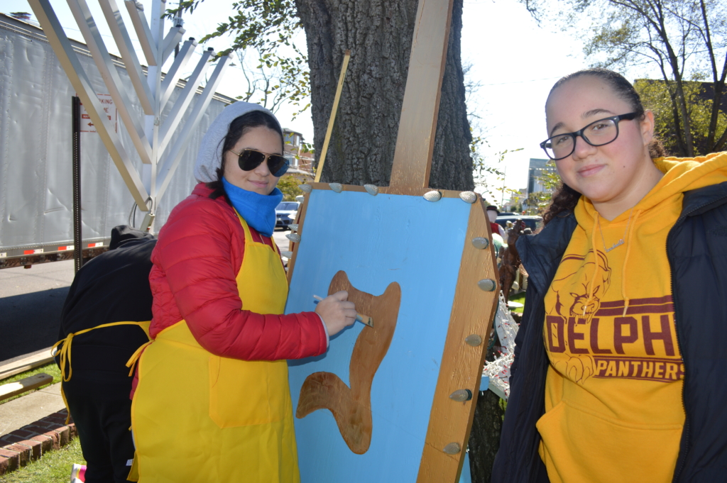 Susan and Isabella helped paint Adelphi’s giant, life-sized dreidels!