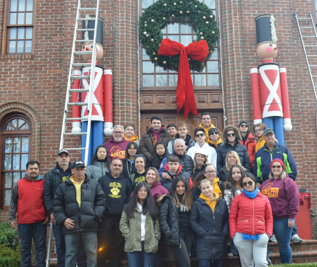 Adelphi Academy of Brooklyn volunteers pose outside Mr. Mure’s newly decorated home!