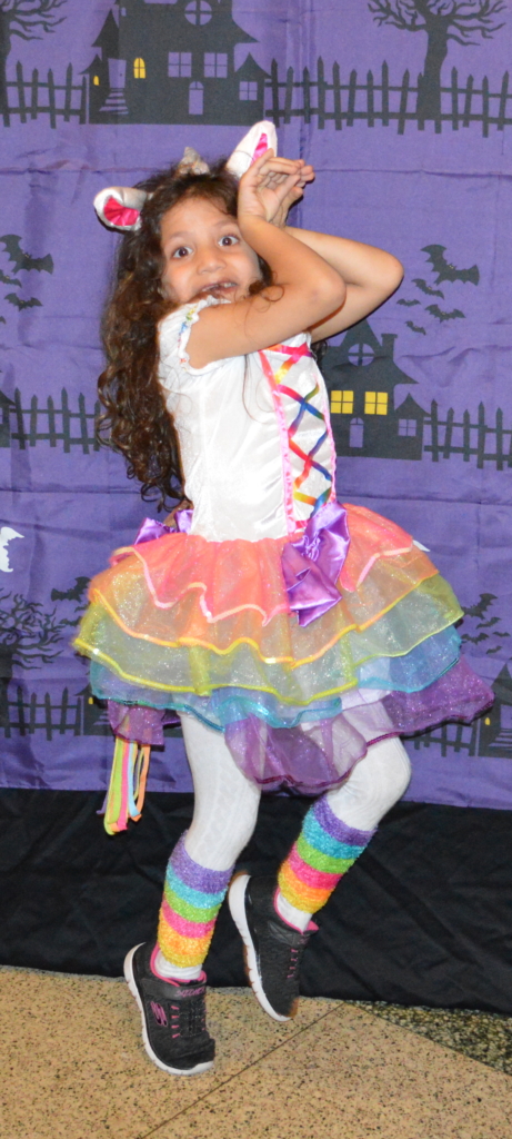 Lower Schooler Reem prances like a unicorn in front of the spooky step-and-repeat!
