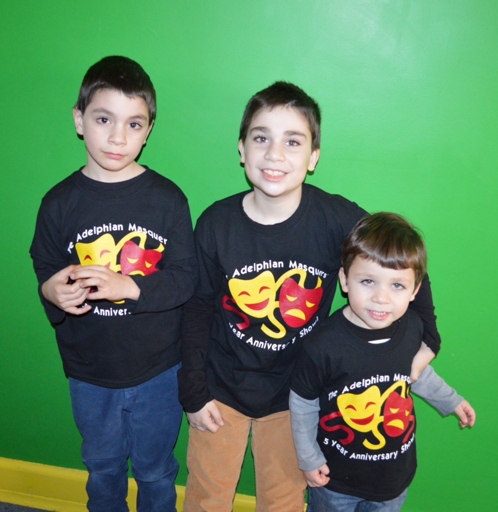 Siblings Lasha, Saba and Luka show off their anniversary show T-shirts on Theater Day!