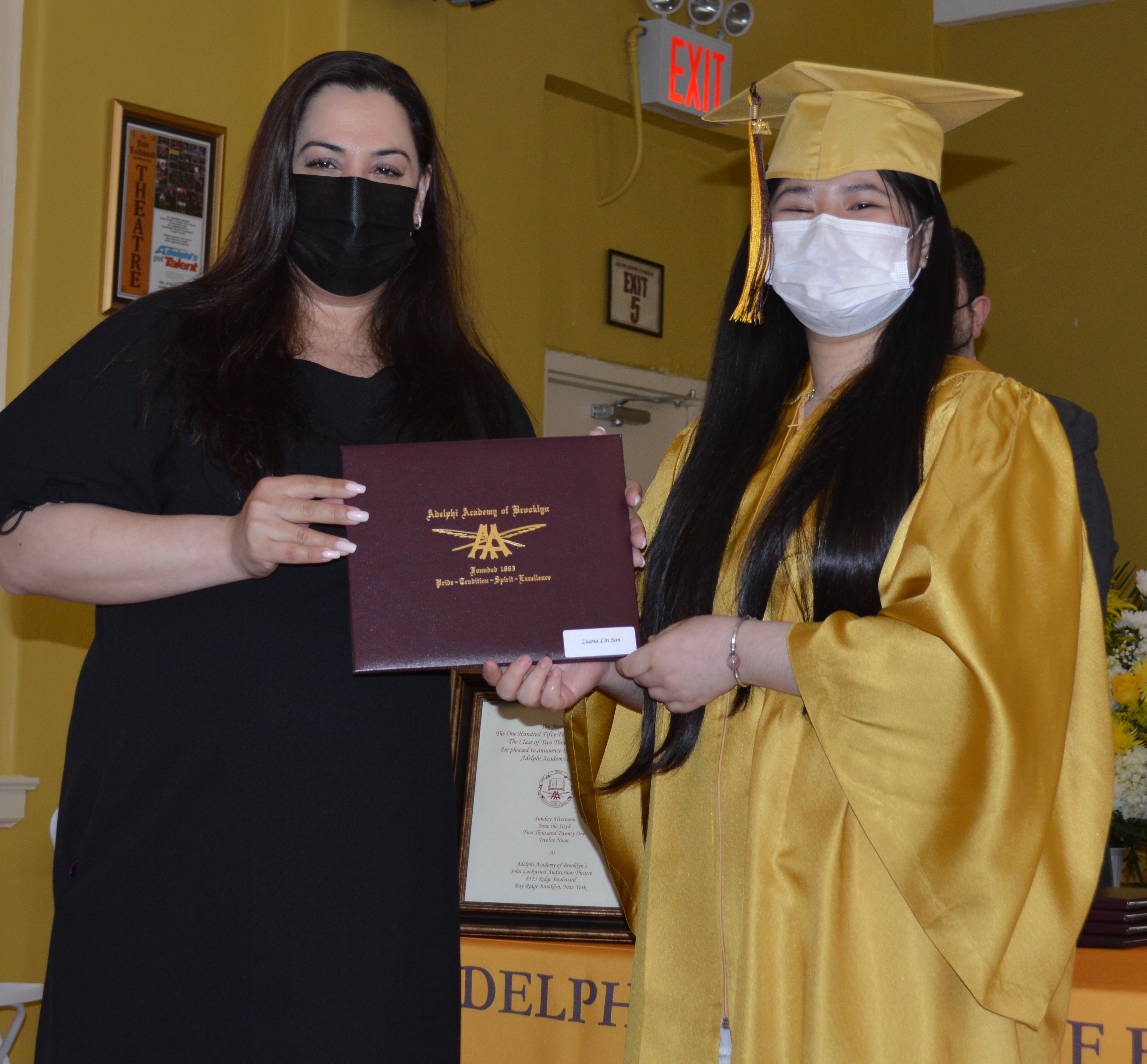 Head of School Ms. Romanos presents Class of 2021 member Luana with her diploma!